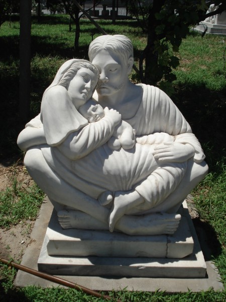 Another statue on the seminary lawn, between trees, before the gate. 