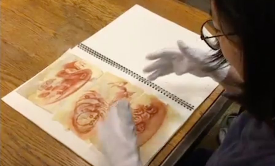 an art historian examines an artifact