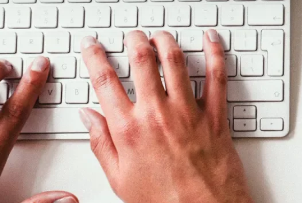 hand typing on keyboard