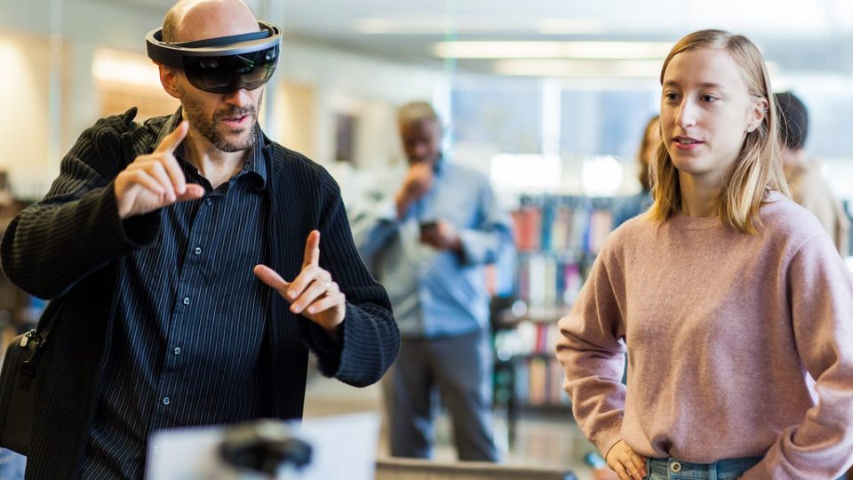two people use an augmented reality visor