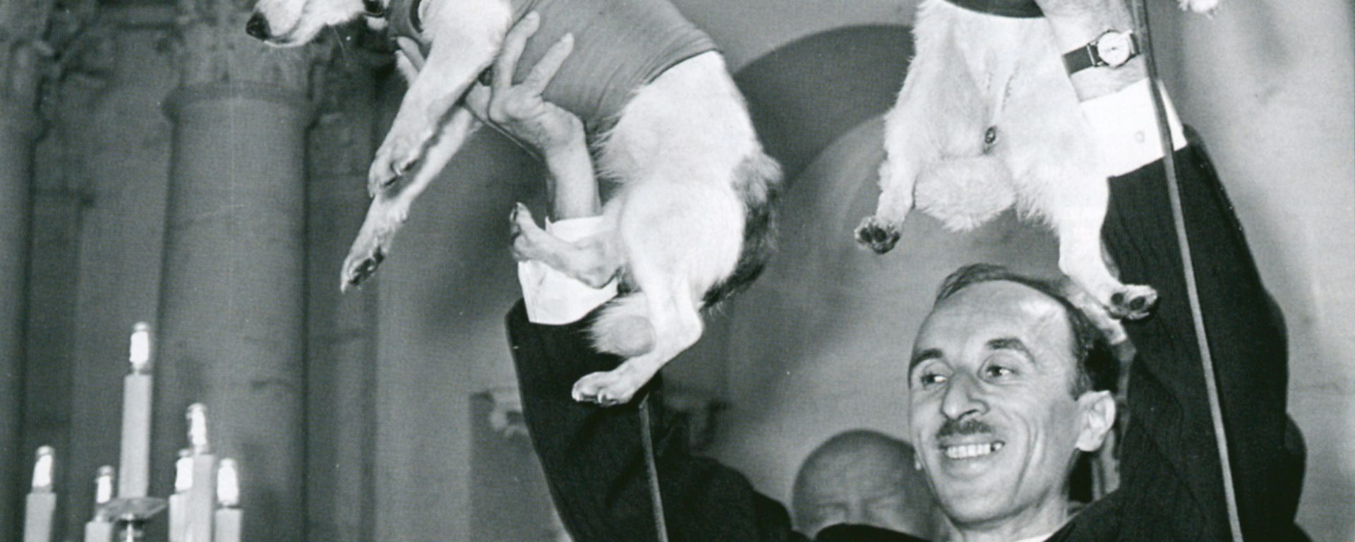 Former director of the Institute of Biomedical Problems, Oleg Georgievich Gazenko, holds up Soviet space dogs Belka and Strelka.