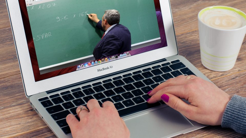 Laptop showing a video of a professor teaching