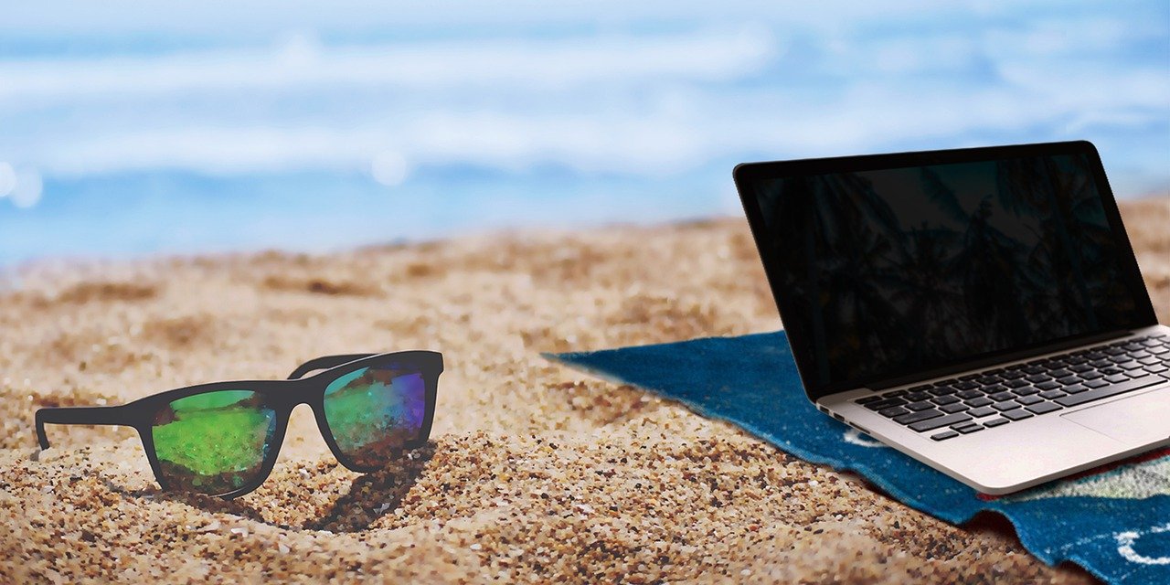 Laptop computer sitting on a beach