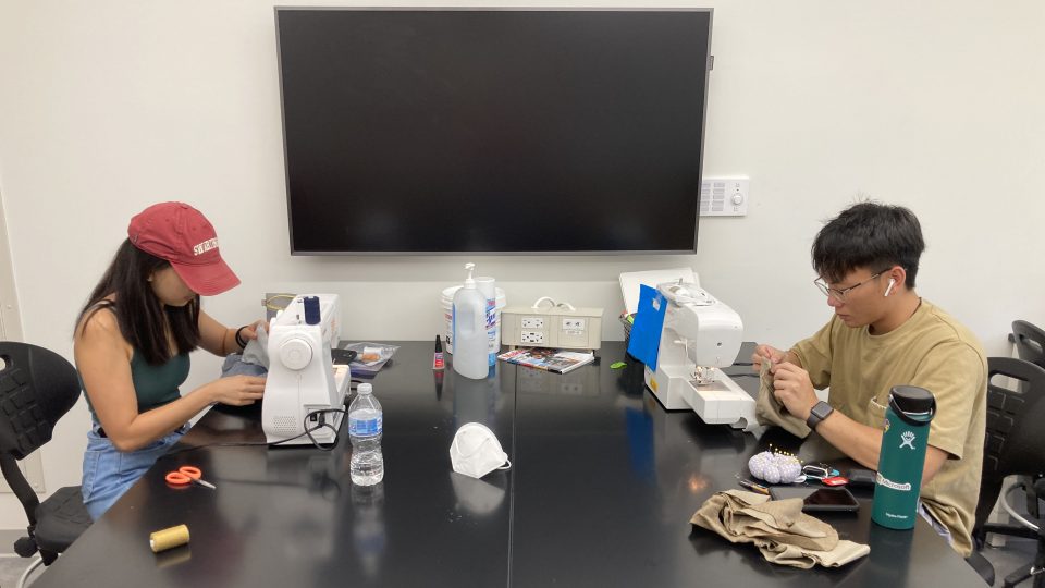 Students Minh Nguyen and Michelle Zhuang using sewing machines.