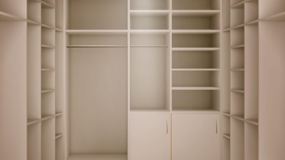 An empty, walk-in closet with many free shelves and a wood floor.