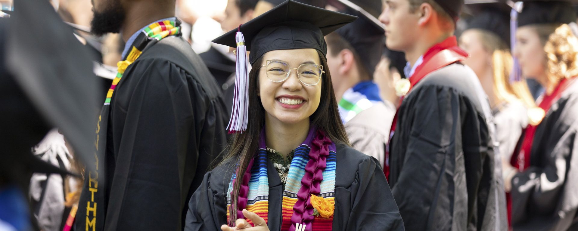 Student facing the camera during commencement on the campus on Swarthmore College campus