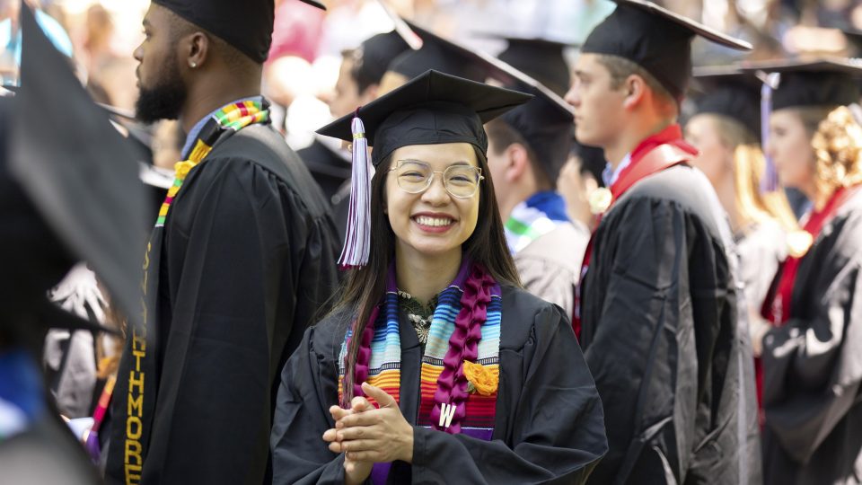 Student facing the camera during commencement on the campus on Swarthmore College campus