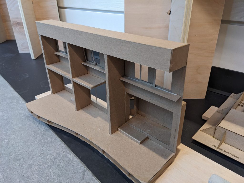 a small model of the facade of a building made from cardboard
