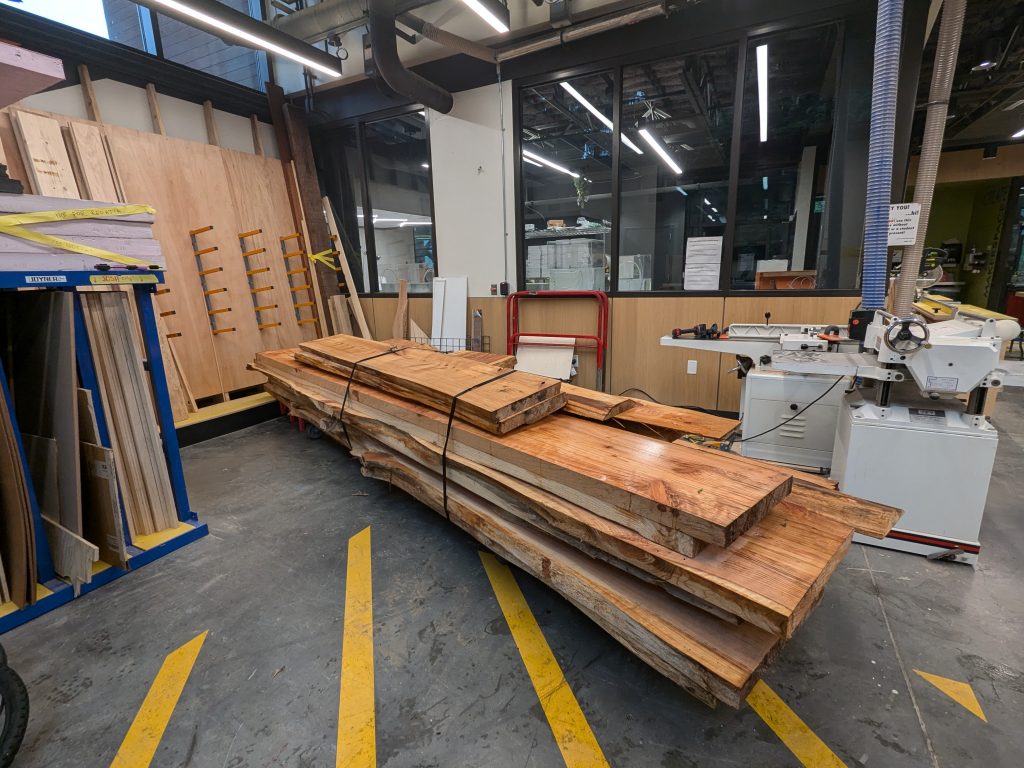 a wide-angle view of a large stack of milled wood boards