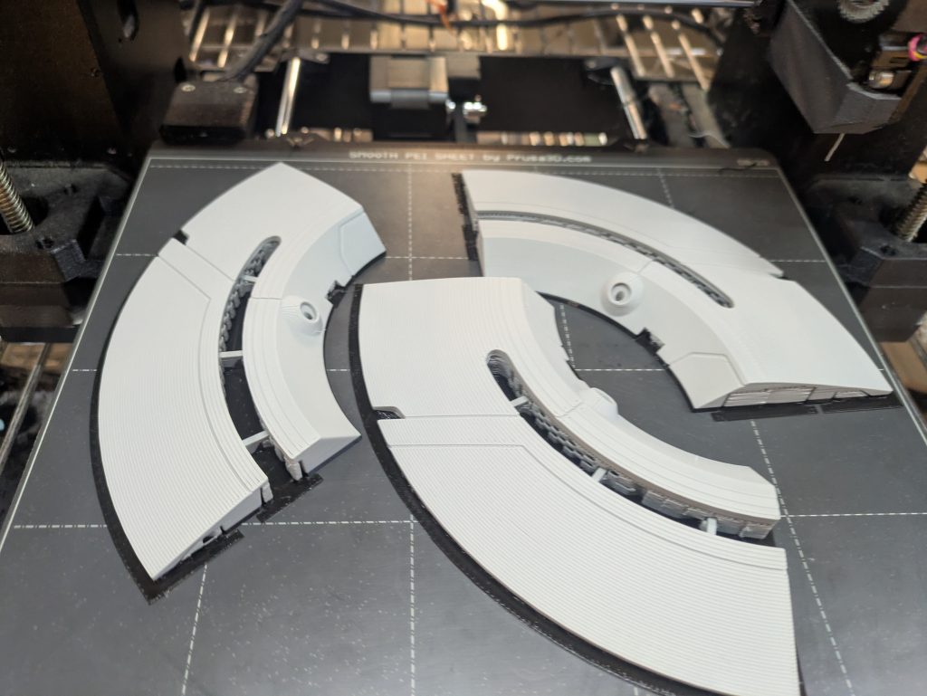 techy-looking fragments of a Tron-themed costume on a 3D printer bed