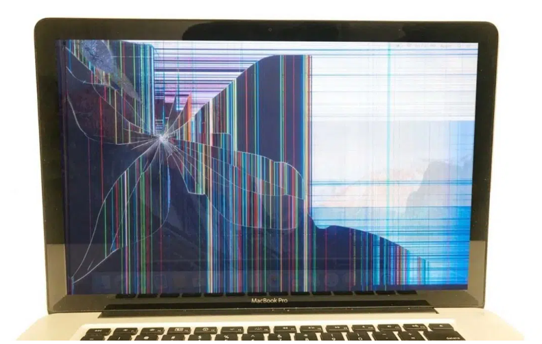 A MacBook wit a visbly cracked screen