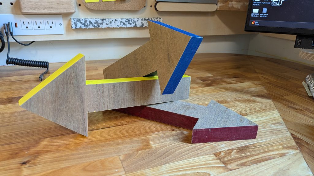 closeup of wooden arrows with colorful painted edges in a workshop